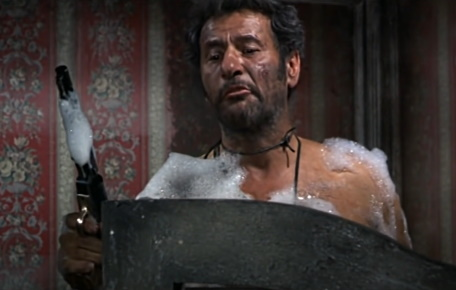 Tuco, mid-bath under a mound of suds, leveling a revolver at an intruder in The Good, the Bad and the Ugly.